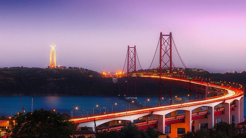 View on the bridge Ponte 25 de Abril and Cristo Rei illuminated.