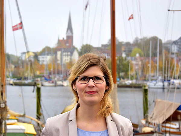 Portrait of an employee in front of the Flensburg Harbour.