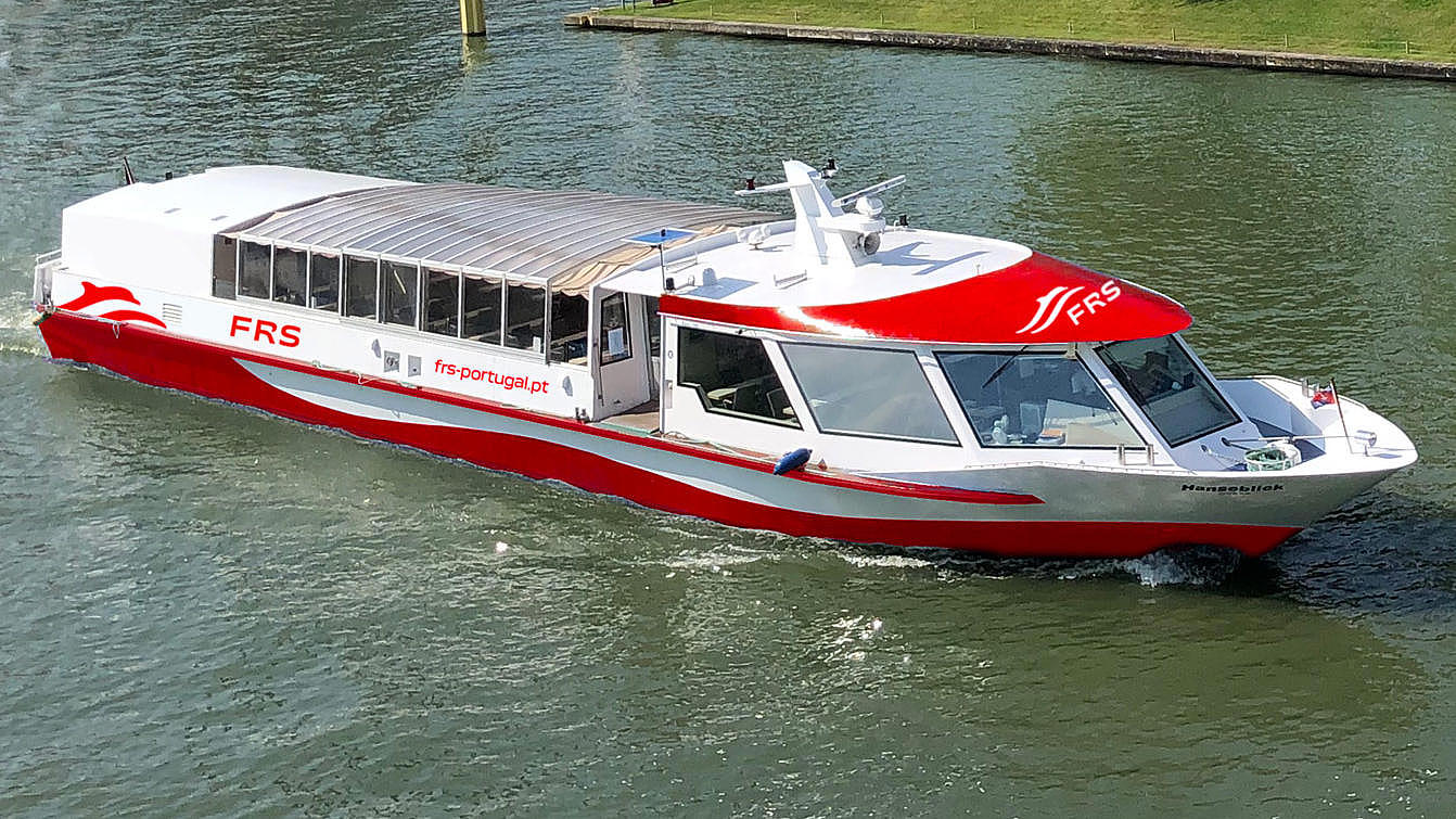 Red and white colored boat on a river The vessel MS "Hanseblick" with new painting.