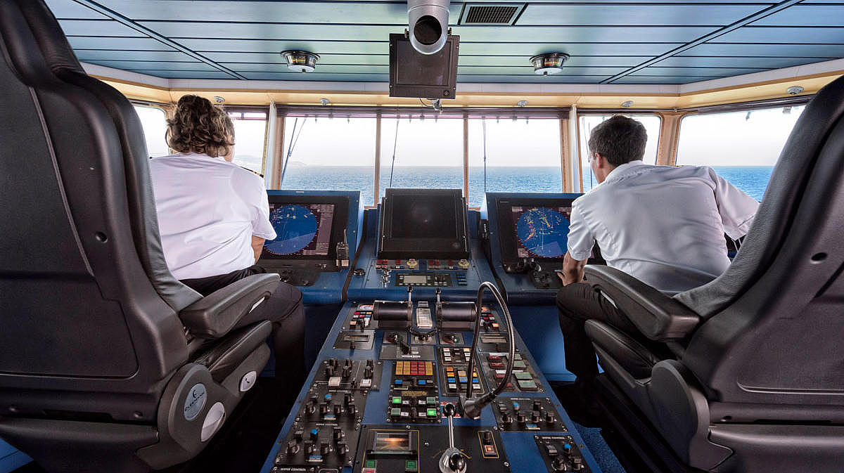 Two people in the cockpit of our ship Tarifa Jet.