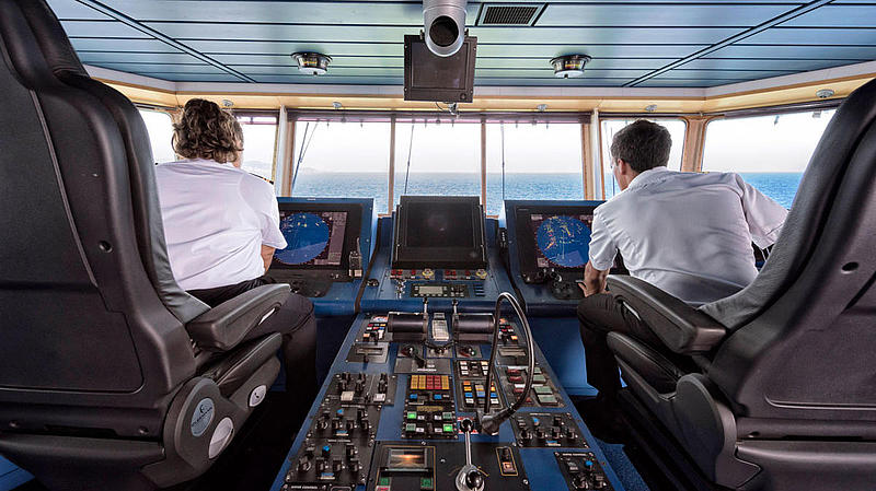 Two people in the cockpit of our ship Tarifa Jet.